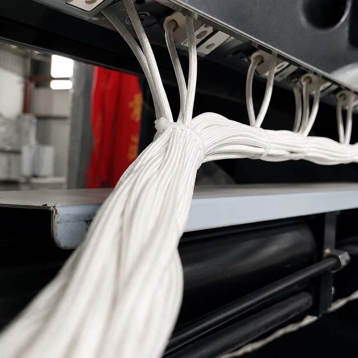 94V-0 grade cable ties securing white wire harnesses inside electrical equipment