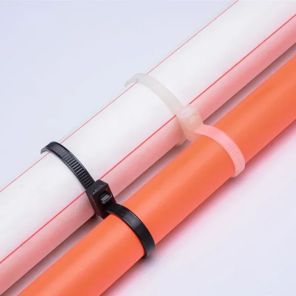 Double head cable ties separating orange and white pipes