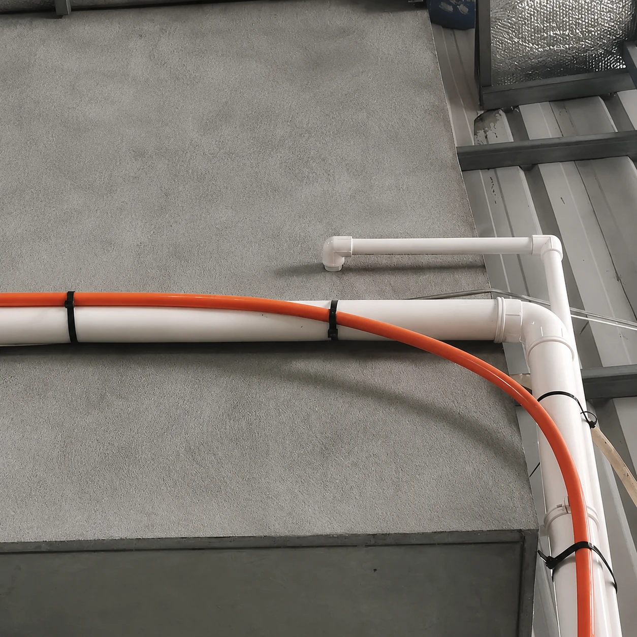 8.8mm extra heavy duty cable ties securing pipes and orange cable
