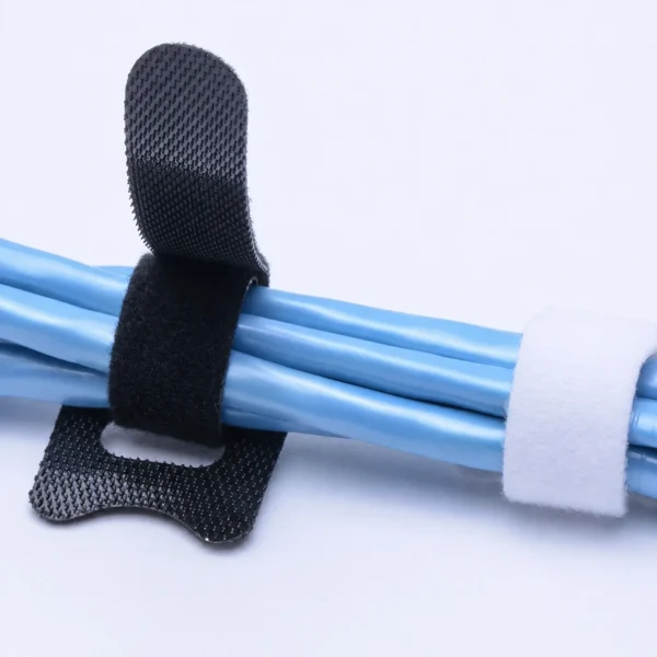 Black and white magic cable ties organizing electrical cables and wire bundles
