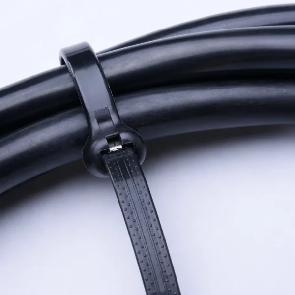Close up of black metal pawl cable tie securing thick black cables