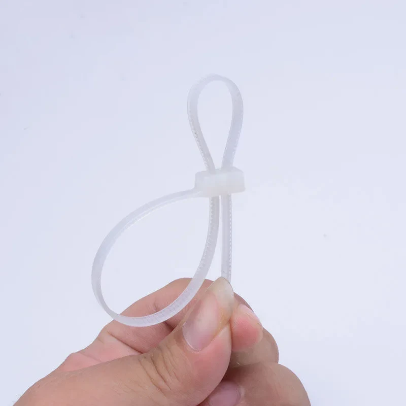 Natural color double head cable ties held by hand
