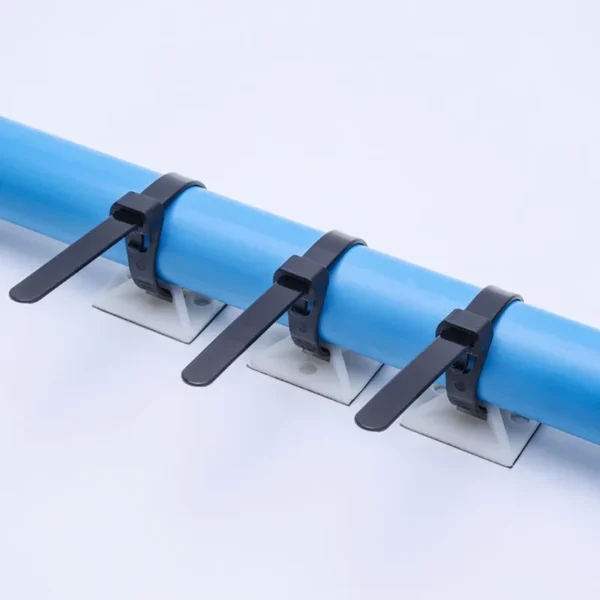 Black releasable cable ties securing blue pipe to mounting base